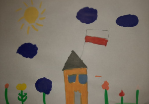 Pomarańczowy dom z zawieszoną flagą Polski. Praca wykonana w gr. I pod opieką Pani P. Filipczak.