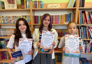 Czytelnicy podczas odbierania nagród i dyplomów za udział w konkursie bibliotecznym.