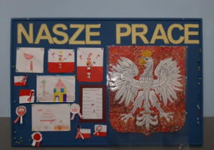 Wystawa prac na tablicy korkowej: kotyliony, flagi i duże godło Polski. Prace przygotowane pod opieką Pani P. Filipczak i Pani A. Kosińskiej.