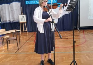 Uczennica klasy 8c gra na skrzypcach wybrany przez siebie utwór