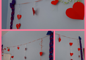 Dekoracja walentynkowa. Na taśmie zawieszono czerwone serca wycięte z papieru. Po bokach umieszczono kokardy wykonane z bibuły. Całość znajduje się na ścianie.