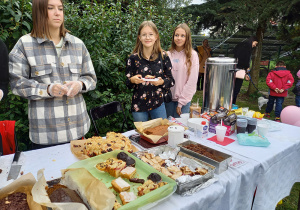 Uczennice ze szkolnej sekcji wolontariatu sprzedające ciasto