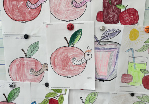 Zdjęcie tablicy z pracami uczniów wykonanych z okazji Dnia Jabłka.